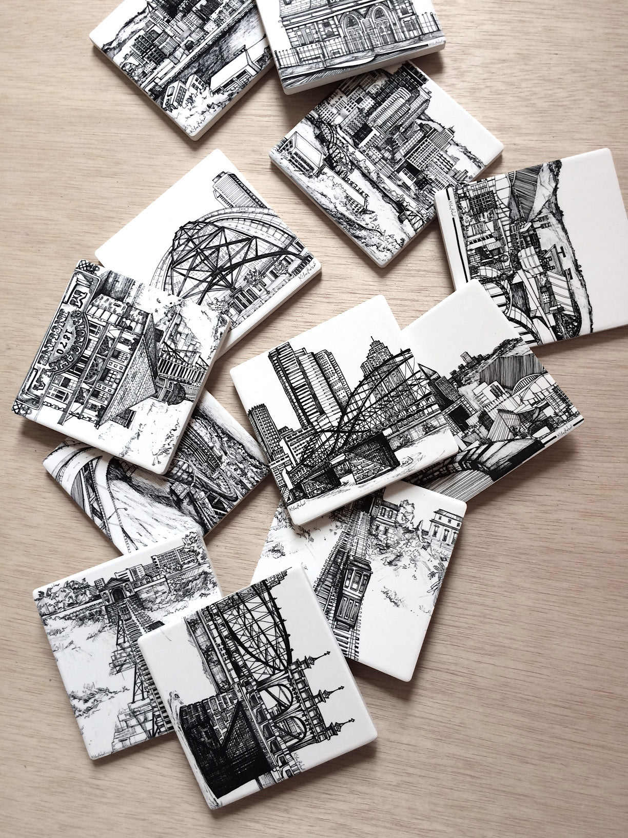 Cork-backed sandstone coaster set with black and white illustration of Pittsburgh Skyline from Curto Park on Bigelow Boulevard